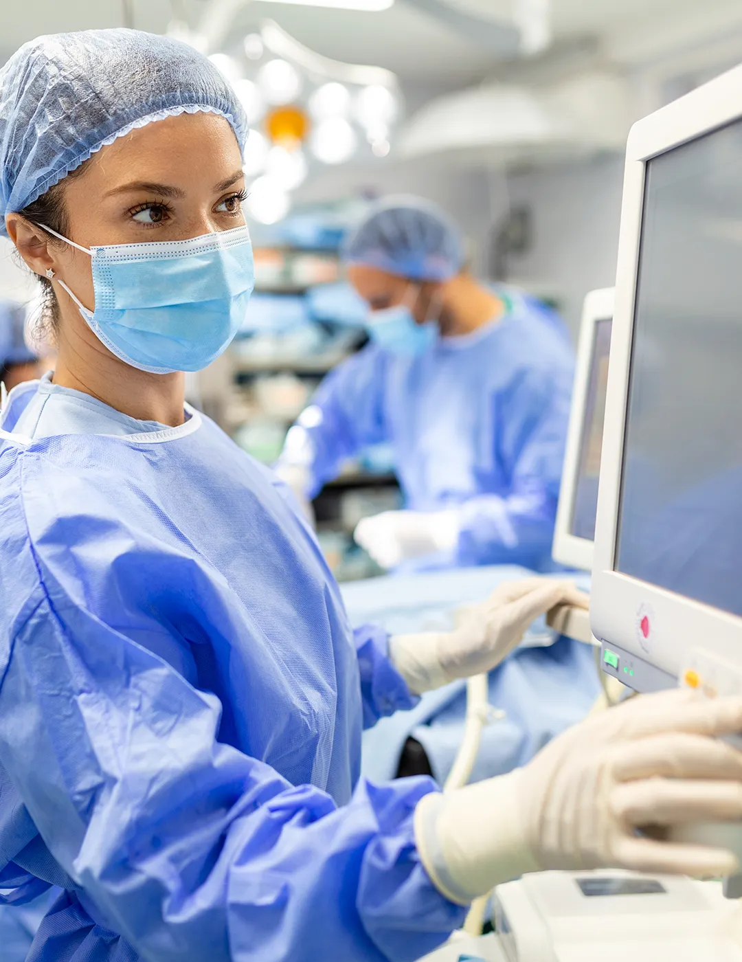 Medical assistant checking information on a monitor.