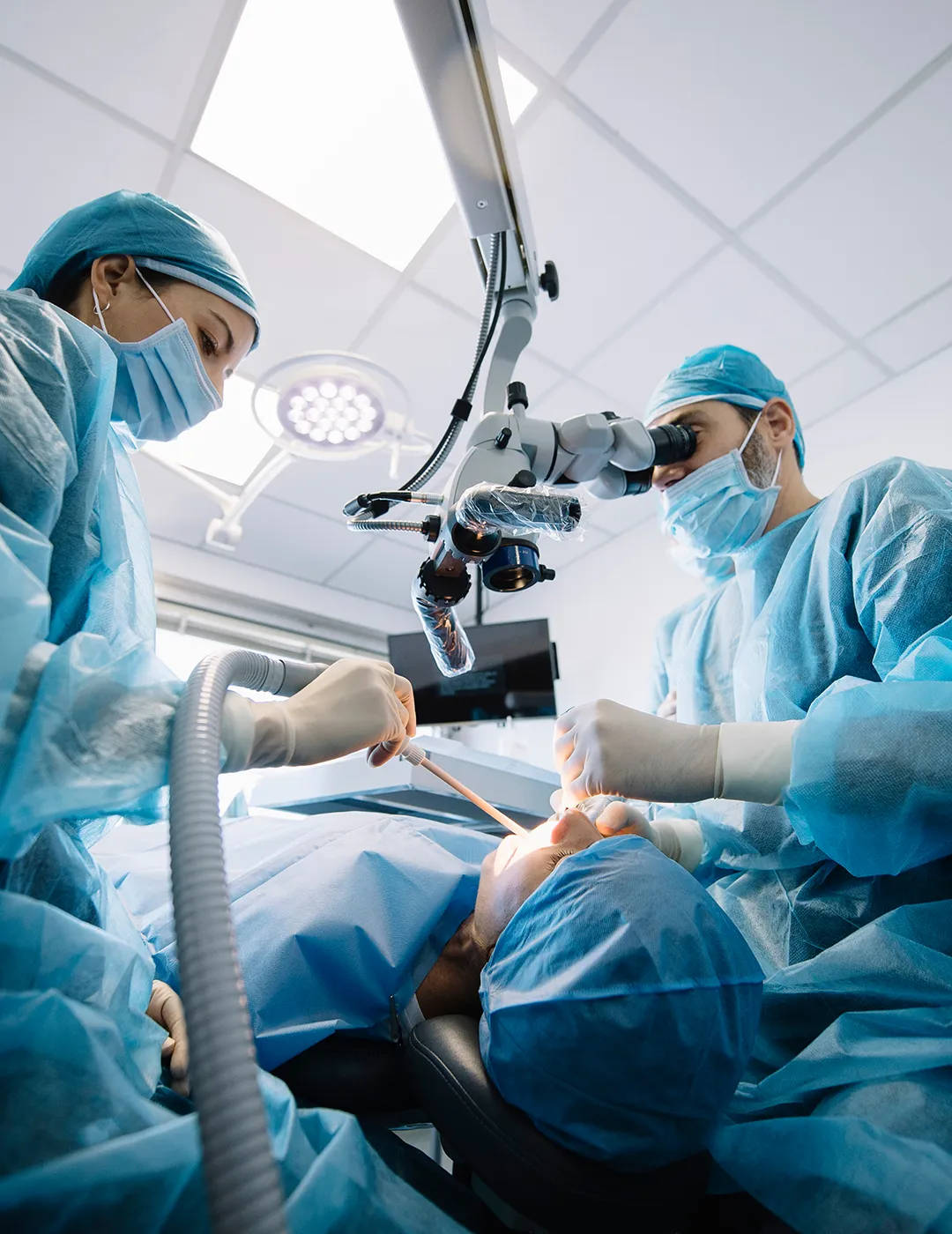 Dentist working while using a microscope.