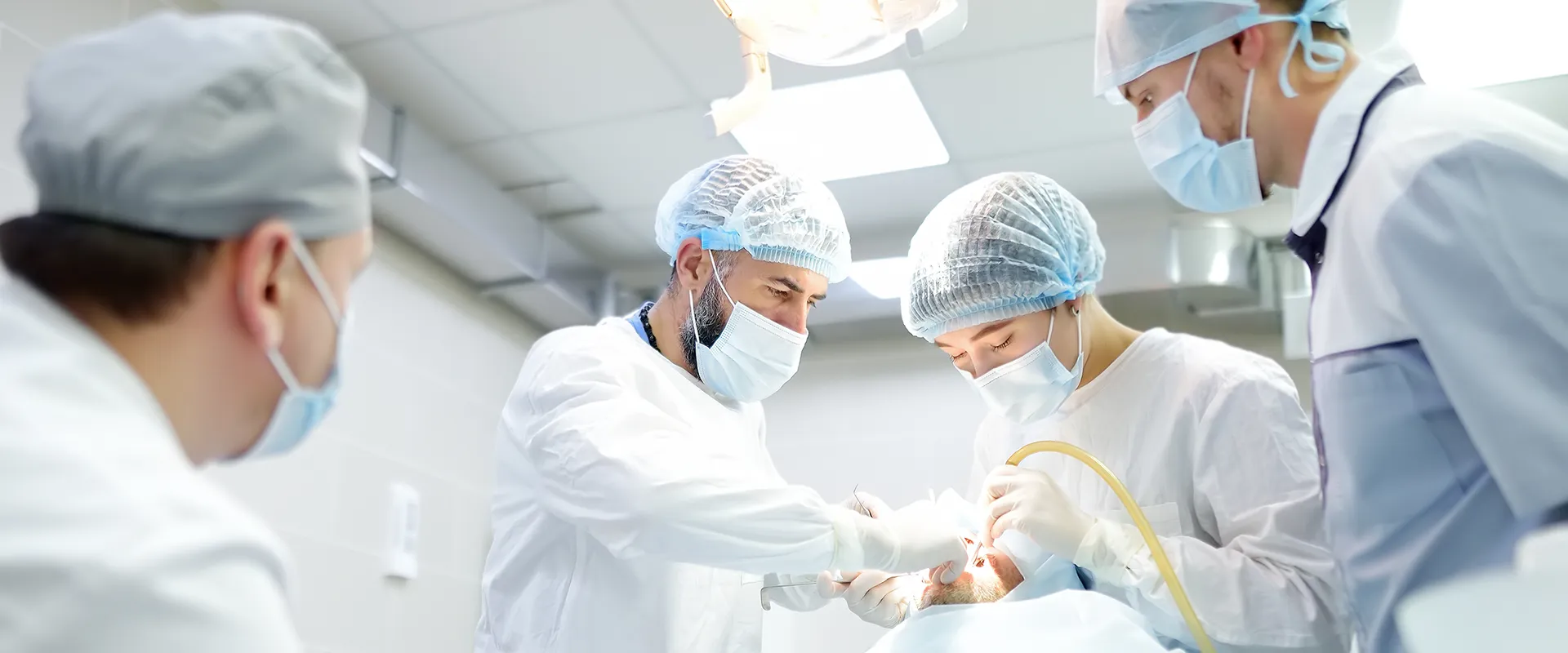 Doctors working in a treatment or operating room.