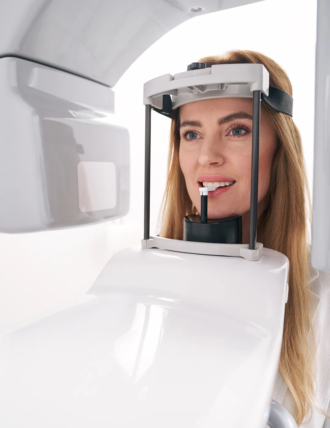 Woman with her head in an X-ray machine.