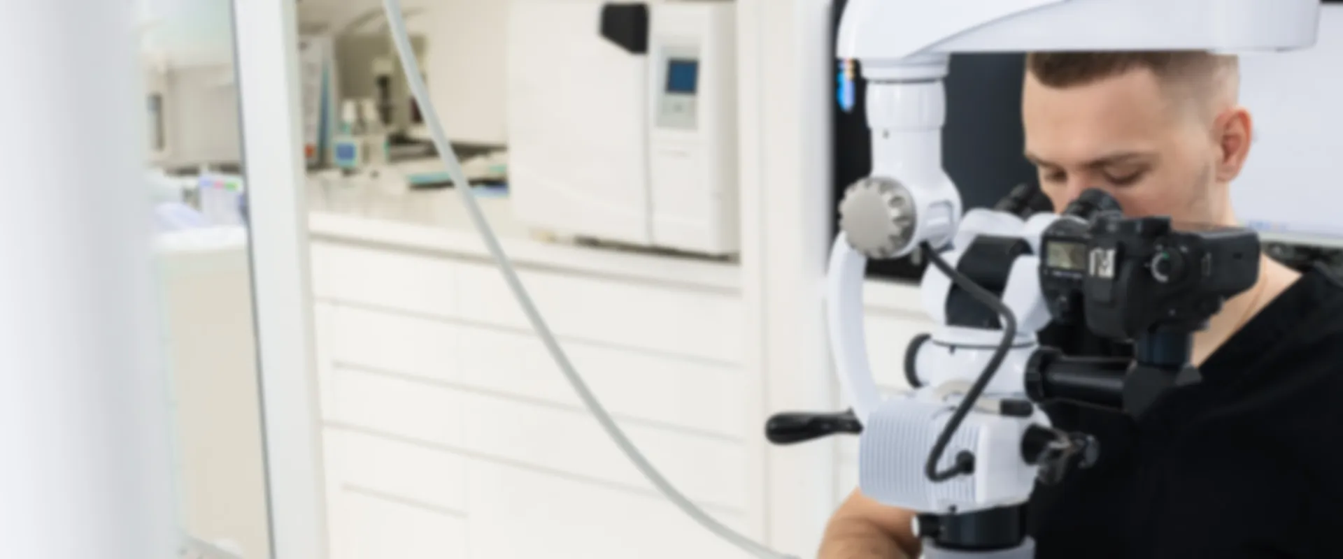 Dentist working while using a microscope.