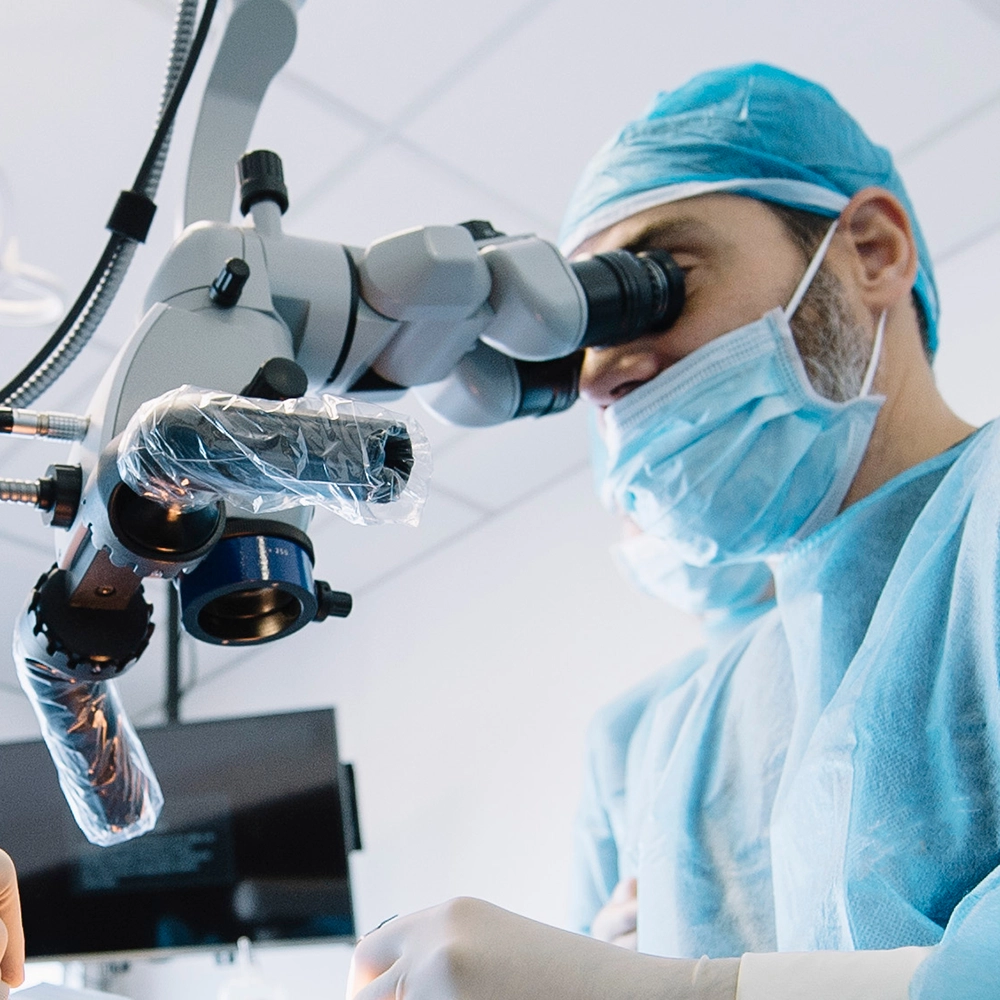 Dentist working while using a microscope.