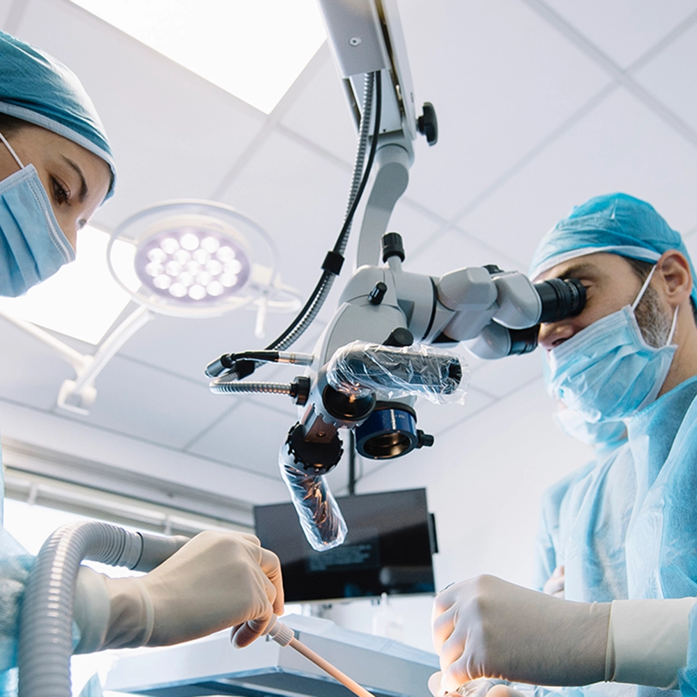 Dentist working while using a microscope.