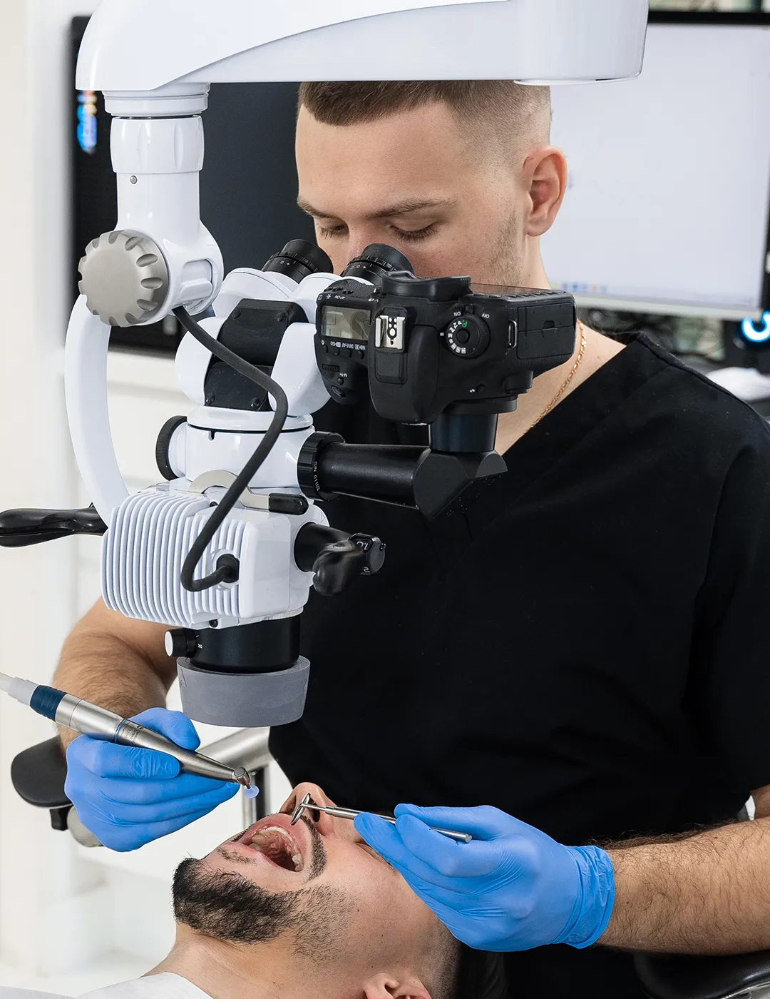 Dentist working while using a microscope.
